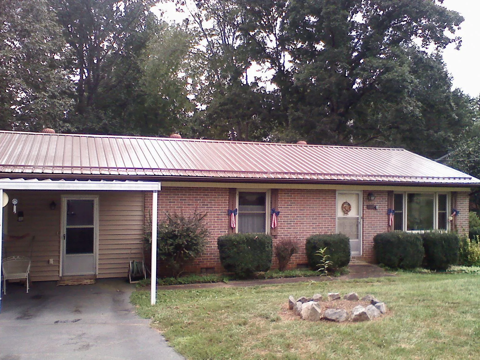 Bronze metal roof and carport on a brick ranch home — Roof Repair work by our crew in Overpeck
