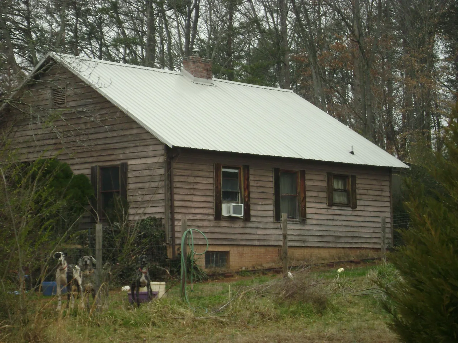 White metal roof on an old wood sided farmhouse, from a Metal Roof Installation job in Overpeck